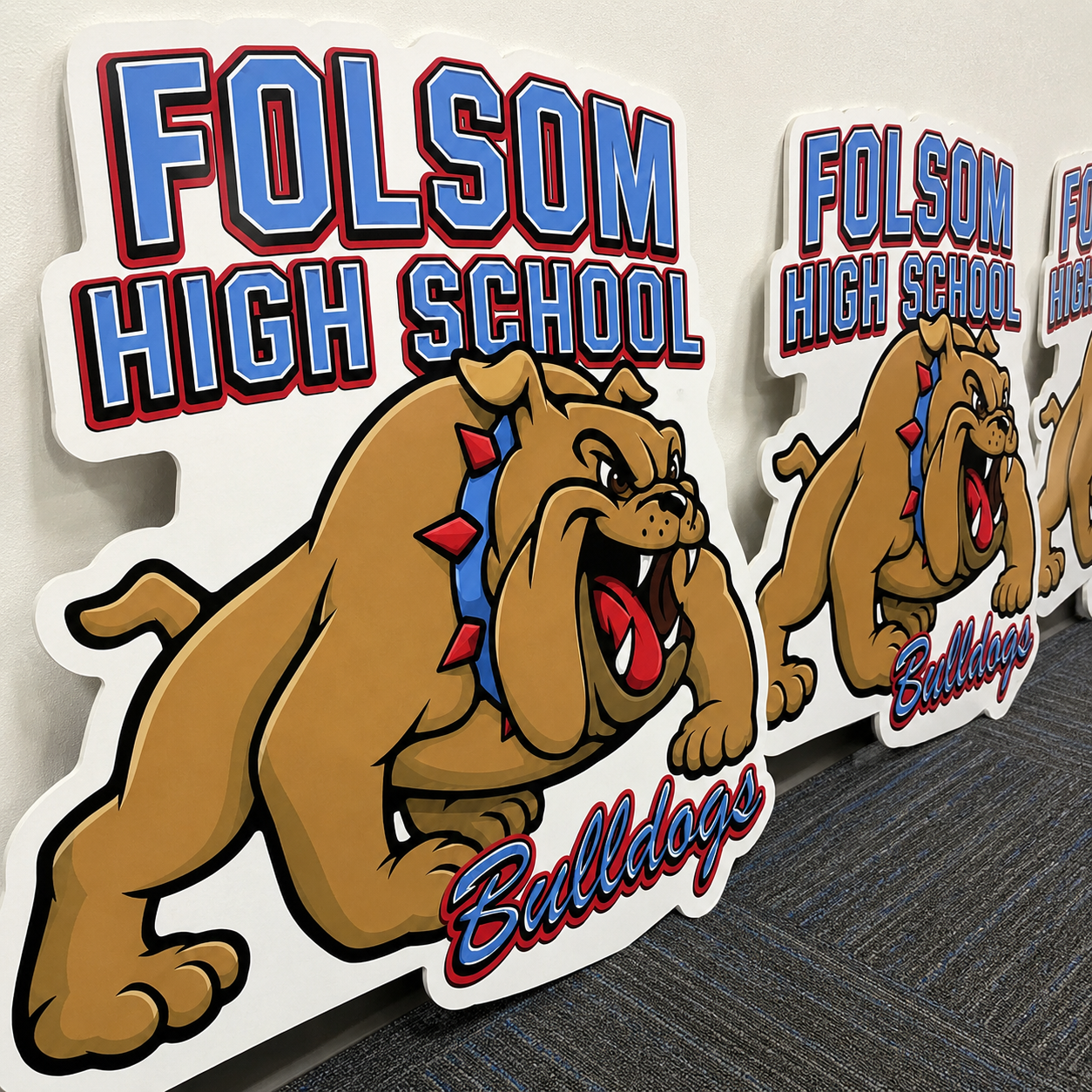 A school mascot sign cut with a bold white outline.
